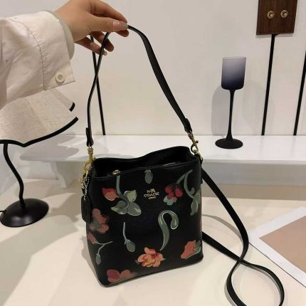 Coach Andy Crossbody handbag featuring a floral cluster print.